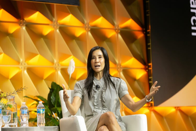 CREW Network female on stage speaking